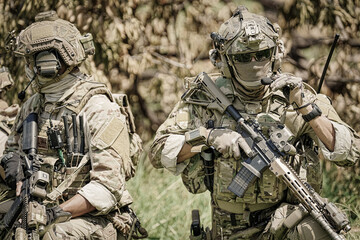 Fototapeta premium United States Army ranger during the military operation. Professional marine soldiers training with weapon on a military range.