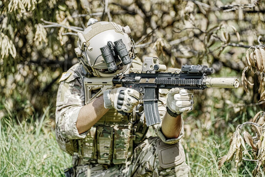 United States Army ranger during the military operation. Professional marine soldiers training with weapon on a military range.