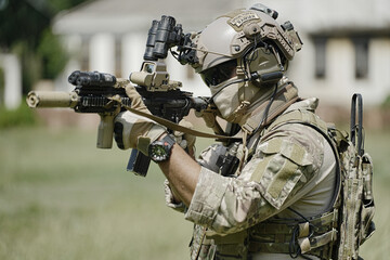 United States Army ranger during the military operation. Professional marine soldiers training with weapon on a military range.