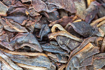 Close-up of dry pressed Chinese tea. Healthy vitamin organic products. The basis for preparing a morning tonic drink for breakfast. Food background. Flat lay, macro, top view, mockup