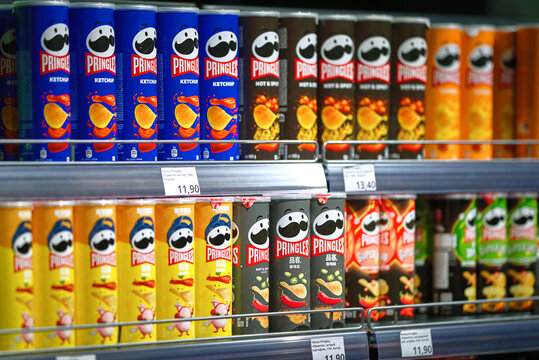 Belarus, Minsk. Jul 2, 2023. Pringles chips hot and spicy taste on shelf of grocery store. Tube of hot and spicy Pringles chips. Various local and imported brands of flavoured chips on store shelf