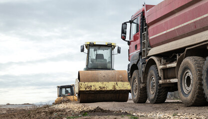 Soil Compactor, single drum road roller and dump truck, dumping truck or dumper lorry with box bed...