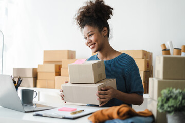 female owner startup business work happy with box at home prepare parcel delivery in sme supply...