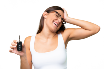 Young caucasian woman holding car keys isolated on green chroma background background has realized something and intending the solution