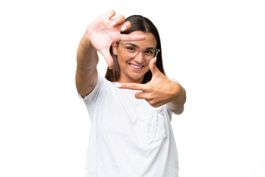 Young caucasian woman isolated on green chroma background focusing face. Framing symbol