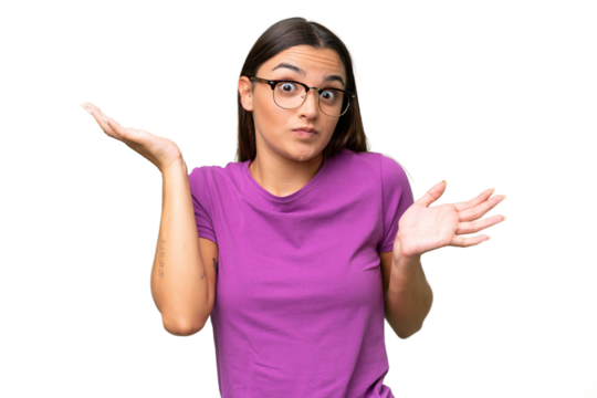 Young caucasian woman isolated on green chroma background having doubts while raising hands