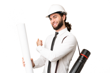 Young architect man with helmet and holding blueprints over isolated chroma key background pointing back