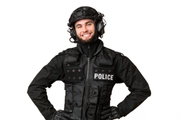 SWAT over isolated chroma key background posing with arms at hip and smiling