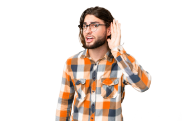 Young handsome man over isolated chroma key background listening to something by putting hand on the ear