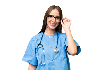 Young nurse caucasian woman over isolated background with glasses and happy