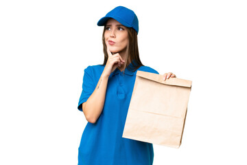 Young beautiful caucasian woman taking a bag of takeaway food over isolated background having...