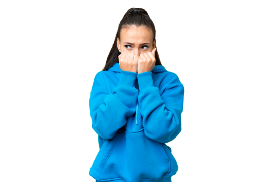 Young Arabian woman over isolated chroma key background nervous and scared putting hands to mouth