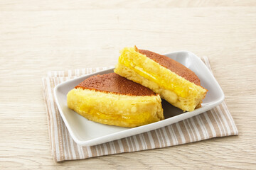 Kue Pukis with pineapple jam, made from flour, yeast, egg, sugar and then baked. Indonesian traditional food
