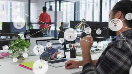 Animation of connected icons over diverse coworkers discussing reports in video call on laptop - Powered by Adobe