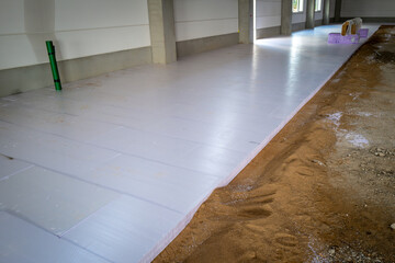 styrofoam panels are laid on the floor of a newly built factory building for insulation purposes