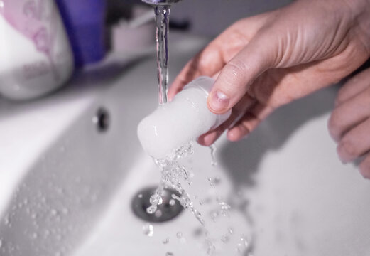 Mineral alum crystal stick. A woman applies a natural antiperspirant to her armpits to reduce odor and sweat. Natural environmentally friendly and safe cosmetics. Safe for people