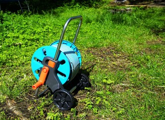 New hose trolley on a meadow in summer