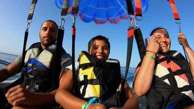A family of three takes off with a parachute
