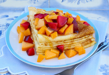 Stack of triangle crepes with fruits