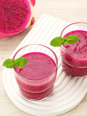 Delicious dragon fruit or pitahaya smoothie and fresh fruits with mint leaves
