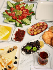 Traditional Turkish Breakfast served with traditional turkish tea on marble table