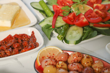 Traditional Turkish Breakfast served with traditional turkish tea on marble table