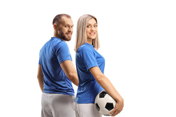 Male and female football players turning back to camera