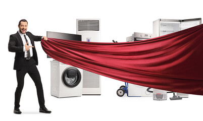 Businessman pulling a red piece of cloth in front of home appliances