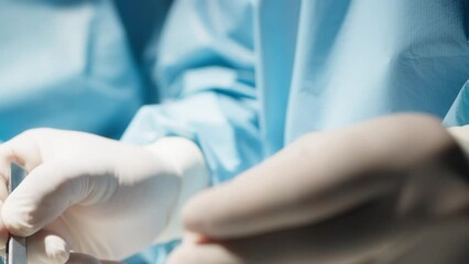 Hands of a surgeon use forceps and scalpel during stomach operation - Powered by Adobe