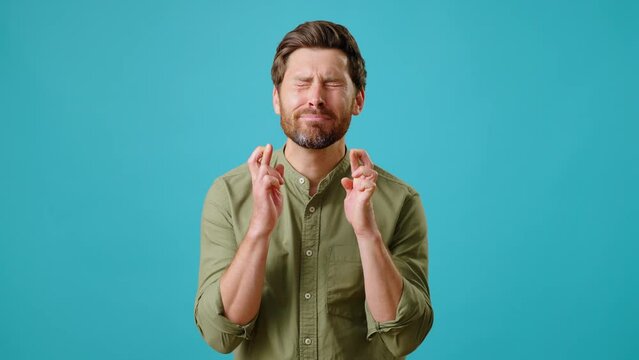 Young man makes wish emotionally showing prayer gesture