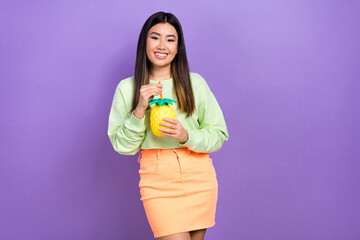 Portrait of pleasant satisfied cute girl wear stylish pullover hold pineapple cup drink cocktail isolated on violet color background