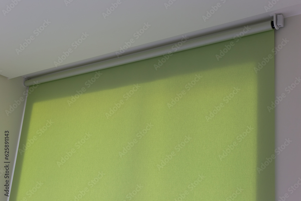 Poster roller blinds automatic close-up on the window. selective focus. motorized shades. green color curta