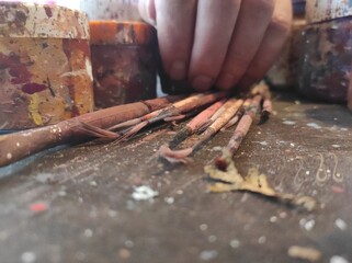 Artistic Inspiration: Painter's Hand Grabs Vibrant Jar of Paint