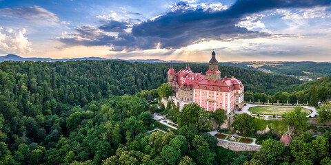 A beautiful aerial panorama of a castle in the woods in summer.