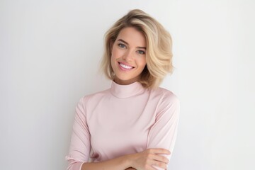 Portrait of a beautiful young woman with blond hair smiling at the camera - obrazy, fototapety, plakaty