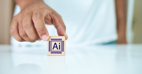 concept of Artificial Intelligence. Hand holding wooden block cube with AI icon. Machine with...