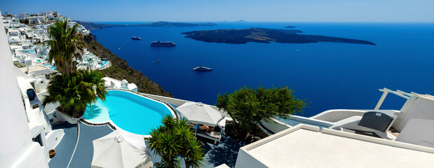 Santorini, Greece. Amazing view of blue sky, sea and pool from luxury resort in Santorini greek island.