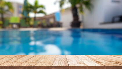 Empty wooden table in front with blurred background of swimming pool