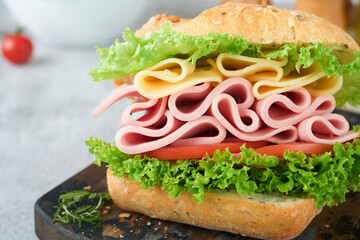 Sandwich. Tasty sandwich with ham or bacon, cheese, tomatoes, lettuce and grain bread. Delicious club sandwich or school lunch, breakfast or snack.