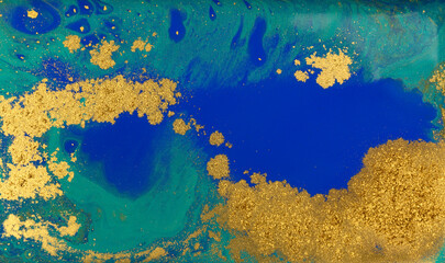 Fototapeta na wymiar Blue and Golden Dust Placer on Liquid Blue Ink Background.