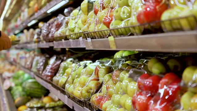 Vacuum-packed fresh fruit on the store shelf in the supermarket