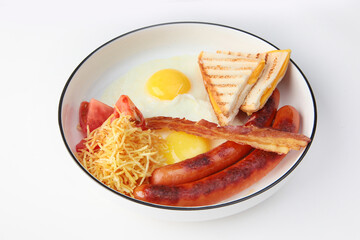 A plate with breakfast. Fried eggs, bacon with sausages and toast on a white plate. The clipping contour. Isolated object. Copy space.