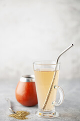 Club-Mate in glass on the table. Caffeinated carbonated mate extract sparkling drink