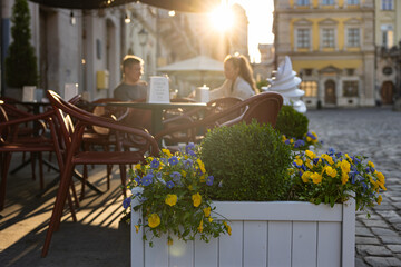 Young couple in outdoor cafe on Market square in Lviv, Ukraine