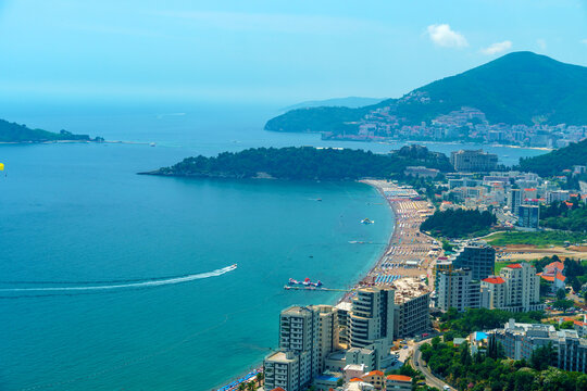 aerial view of the city on the seashore and mountains, panorama of the resorts of Becici and Budva in Montenegro, Adriatic sea, beaches, islands, tourism and travel, summer traveling