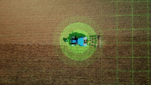 Aerial view autopilot controls an agricultural tractor. Visualization of the environment scanning, sensors and GPS position the vehicle. Smart agriculture of the future, driverless transportation. 4k 