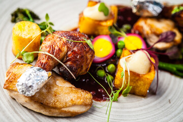 Chicken fillet, Jerusalem artichoke puree, dewberry sauce, potato, quail egg. Delicious healthy traditional food closeup served for lunch in modern gourmet cuisine restaurant - 625928763