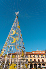 Fototapeta premium Leon, Spain - November 12 2022: Christmas tree in the city center of Leon in Plaza Mayor Square. Streets of Leon decorated with lights and ornaments in anticipation of the Christmas celebration. 