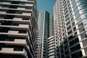 Contemporary residential buildings exterior in the daylight. Modern European residential apartment buildings quarter on a sunny day. Skyscrapers, bottom view