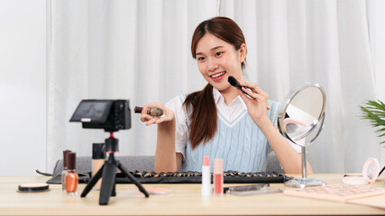 Young beauty influencer is showing to recommend beauty equipment and makeup accessories while recording